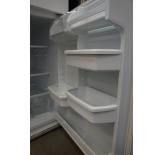 The refrigerator door features gallon-size door bins.