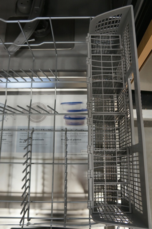 The lower rack has fixed tines and a removable silverware basket.