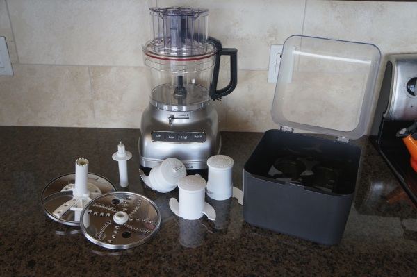 The KitchenAid comes with a number of blade/disc attachments.