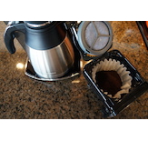 Preparing to brew using a paper filter in the flat-bottomed brew basket.